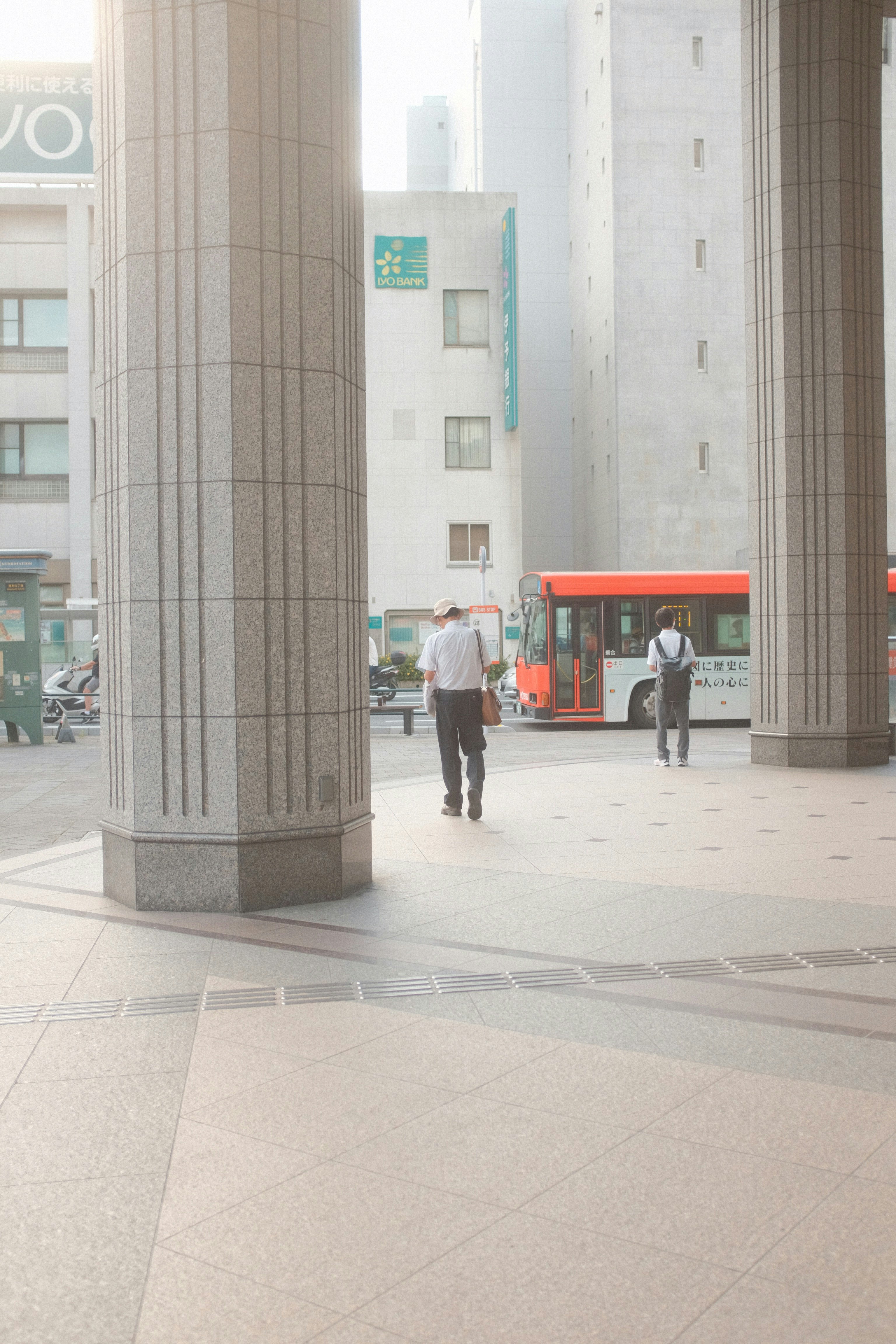 people walking on sidewalk near building during daytime